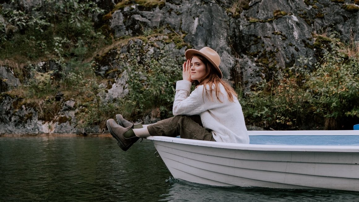 Mujer sentada en un bote – Viaje al extranjero